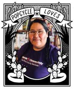Photo of Gabriella wearing a Purple Gabriella For Recorder t-shirt, with a hand drawn black and white frame that reads, "Popcyle Loves" with prickly pear cactus in the foreground
